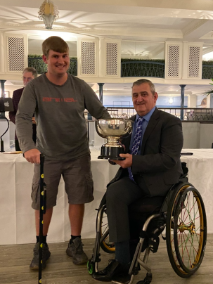Ollie Wellum (left) presented with his award by Gordon Perry